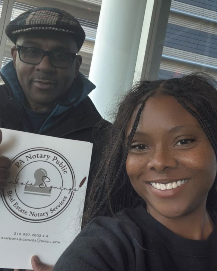 Khalia Luff with a satisfied client holding the Sankofa Signings notary folder