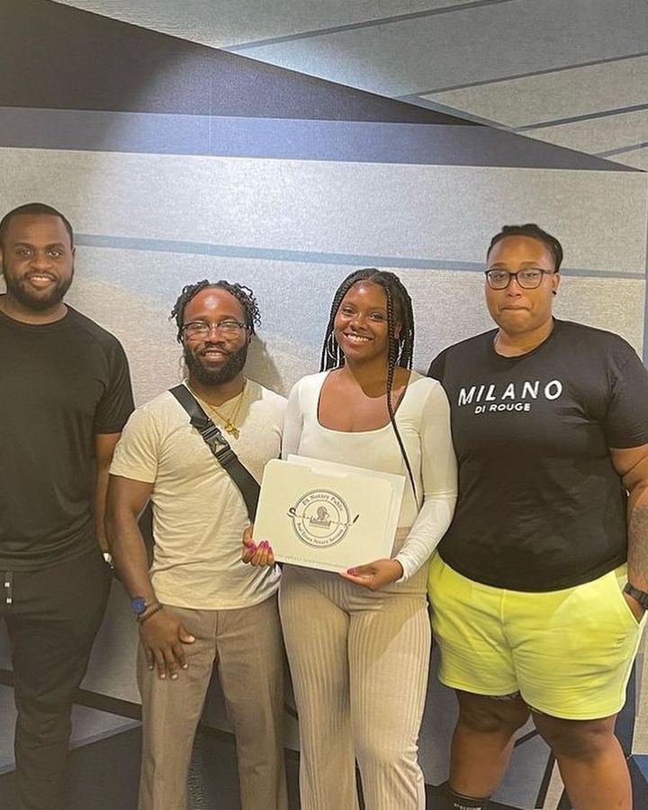 Khalia Luff of Sankofa Signings with a group of happy clients after a Philadelphia notary signing