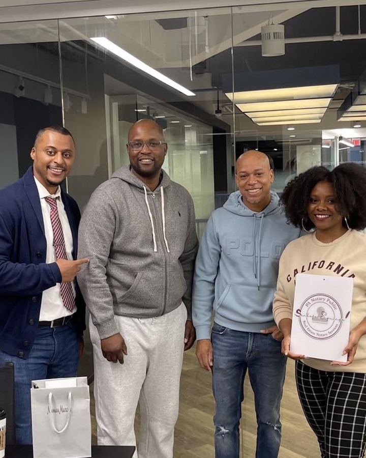 Khalia Luff of Sankofa Signings with clients at a downtown Philadelphia office signing